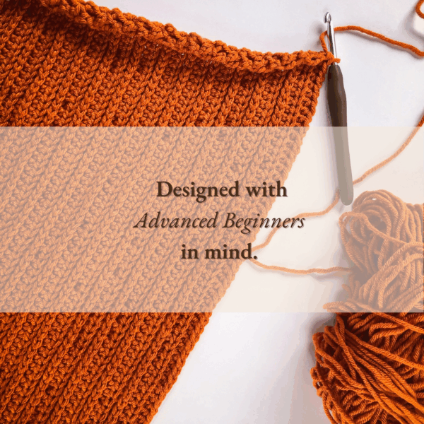 Flat lay photo of an in-progress crochet pumpkin baby sleep sack made with orange yarn, showcasing the ribbed knit-like stitch pattern and ergonomic crochet hook. Text overlay reads “Designed with Advanced Beginners in mind.”