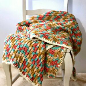 Thick Multicolor Crochet Chunky Blanket on a white chair