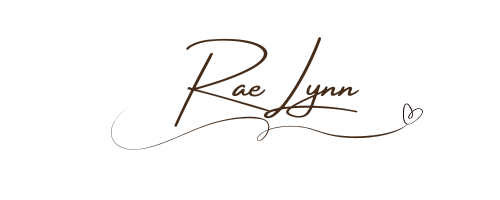 A signature graphic of the name "RaeLynn" in elegant script with a heart flourish at the end, displayed on a parchment-style background. The style conveys a warm, personal touch aligned with a modern vintage aesthetic.
