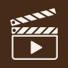 Video tutorial icon featuring a vintage film clapperboard with a play button, representing on-demand crochet video support and learning.