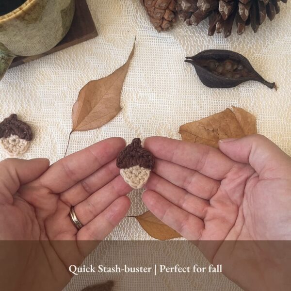 Small crochet acorn appliqué held in both hands — quick stash-buster pattern for fall projects