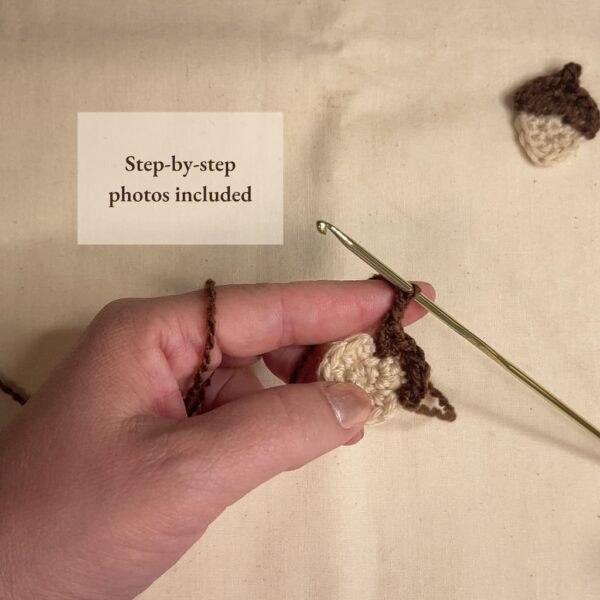 Crochet in progress showing yarn and hook while stitching the acorn appliqué — PDF includes step-by-step photos.