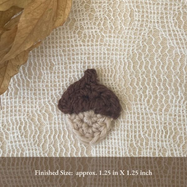Finished crochet acorn appliqué approximately 1.25 inches square — small embellishment pattern.